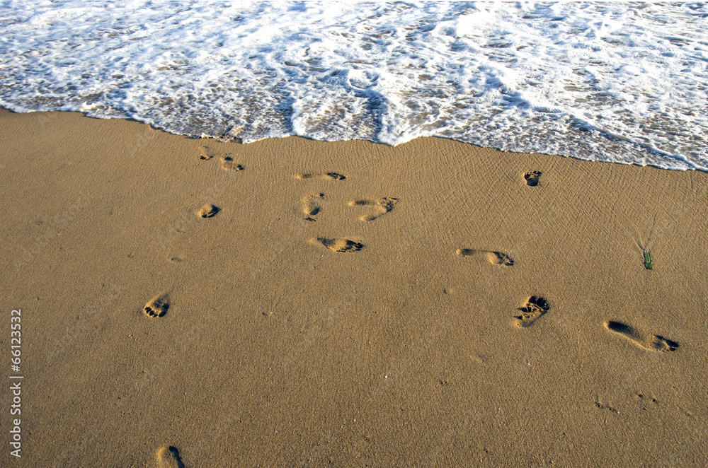 barefoot footsteps on ocean beach sand and wave barefoot footsteps on ocean beach sand and wave