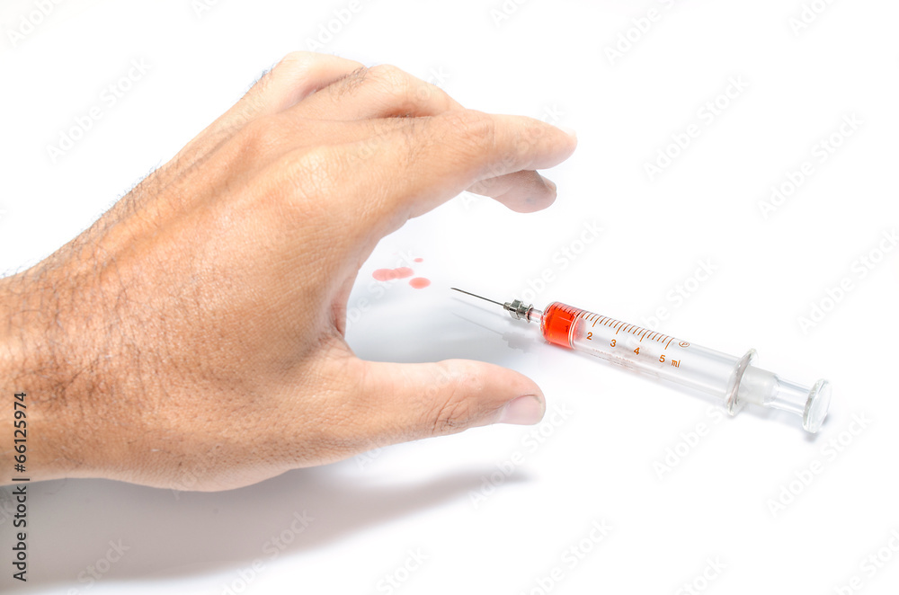 Fototapeta premium Hand with heroin syringe. Close-up photo.