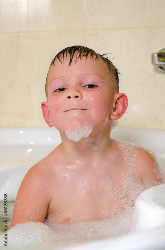 Young boy bathing in the tub