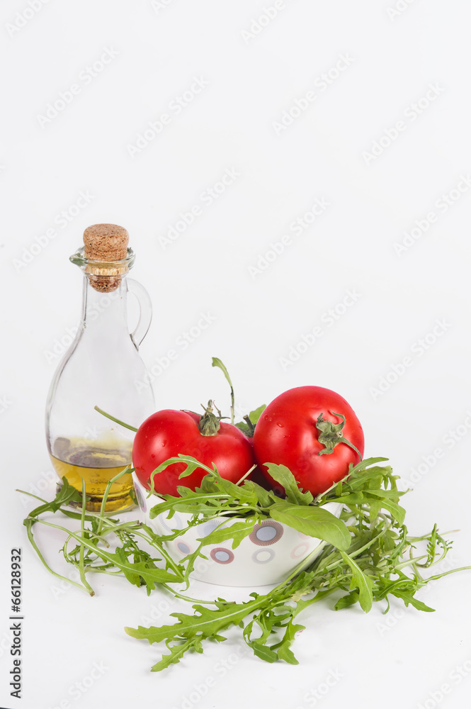 fresh summer salad: red ripe tomatoes, rucola salad and olive oi fresh summer salad: red ripe tomatoes, rucola salad and olive oi