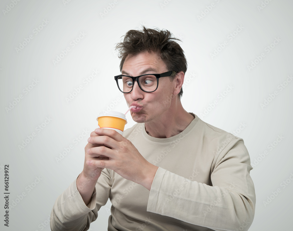 Funny man in glasses drink through a straw Funny man in glasses drink through a straw