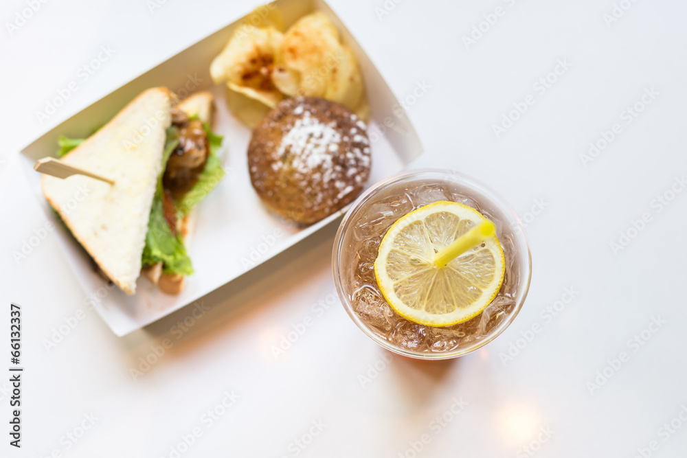 Top view of iced tea and lemon with sandwiches Top view of iced tea and lemon with sandwiches
