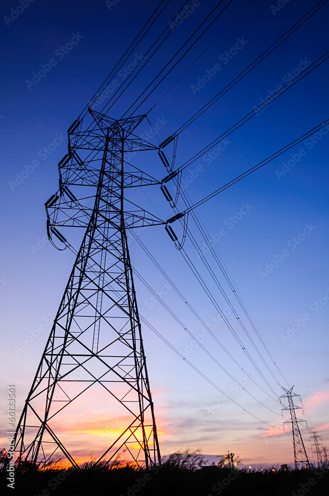 High voltage transmission tower in sunset scene twilight