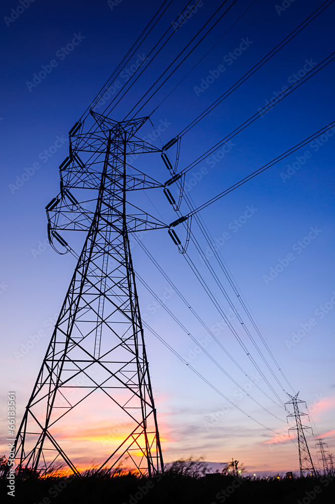 Fototapeta premium High voltage transmission tower in sunset scene twilight