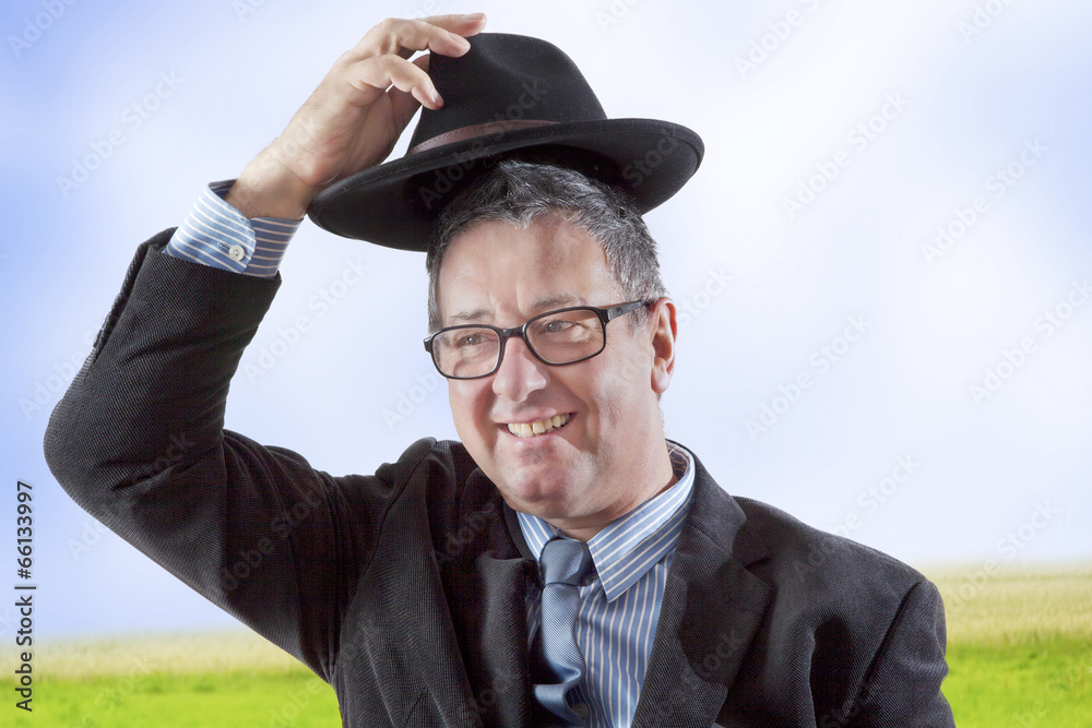 Man lifts hat in greeting