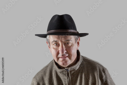 Serious man with hat and anxious glance
