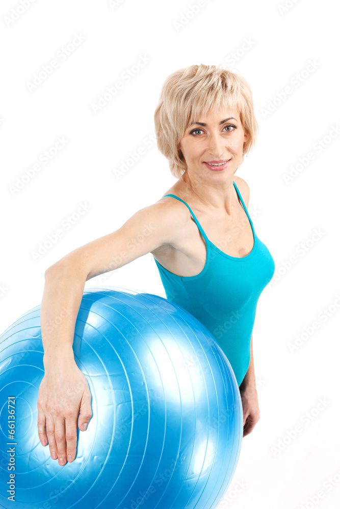 aged blond lady holding fitness ball. aged blond lady holding fitness ball.