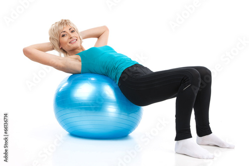 aged lady lying on fitness ball.