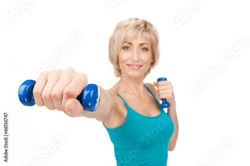 aged woman workout using dumbbells.