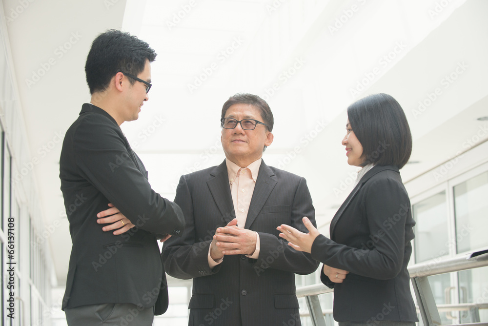 singaporean business team meeting over their office singaporean business team meeting over their office
