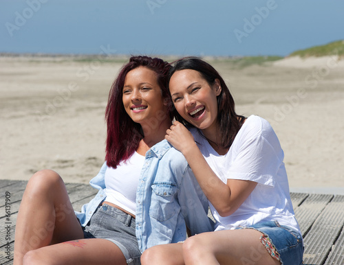 Two sisters smiling at the beach
