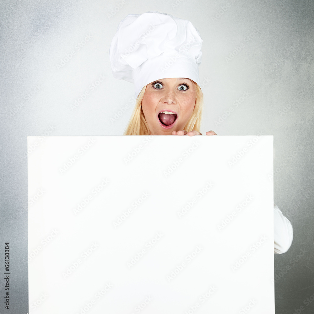 Female cook shows white blackboard with copyspace Female cook shows white blackboard with copyspace
