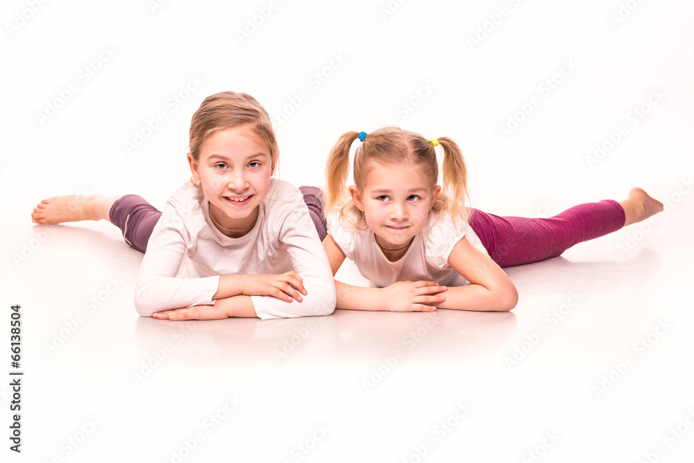 Sportive girls on a floor isolated over white Sportive girls on a floor isolated over white