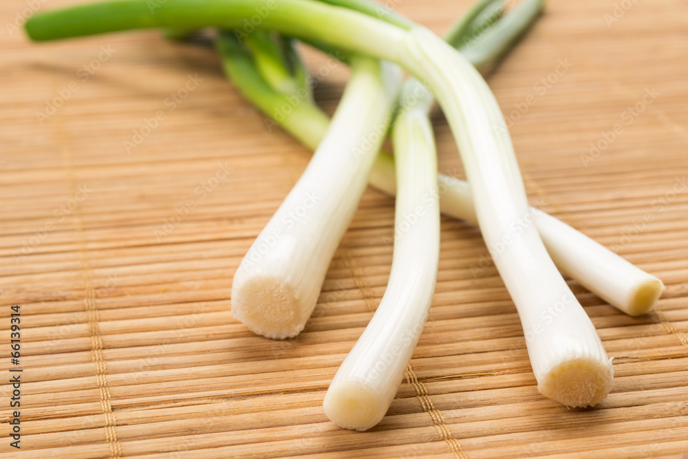 Bunch of green spring onions on a wooden background. Bunch of green spring onions on a wooden background.
