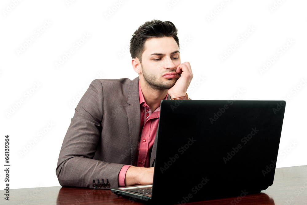 Young business manager checking his laptop. Young business manager checking his laptop.