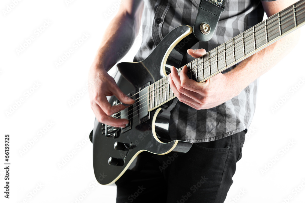 Fototapeta premium Young man playing guitar over white background