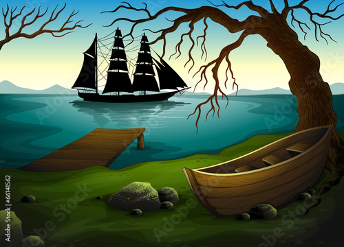 A black ship at the sea across the boat under the tree