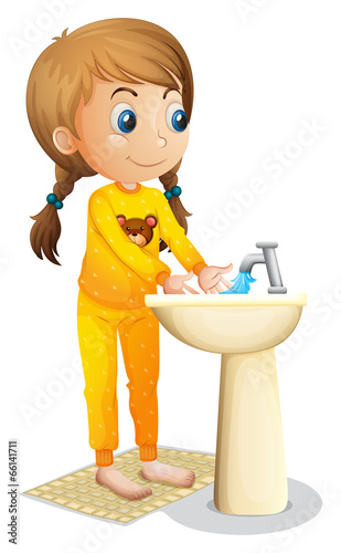 A cute young girl washing her hands