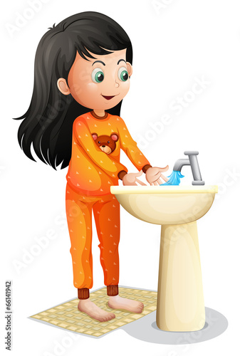A young girl washing her hands