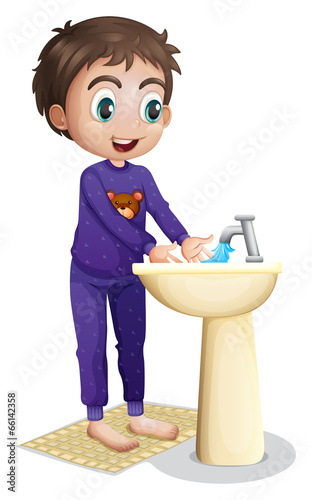 A boy washing his hands