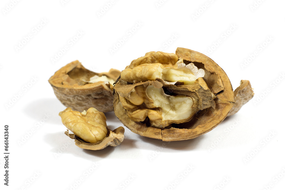 Closeup of a cracked walnut isolated on white background Closeup of a cracked walnut isolated on white background