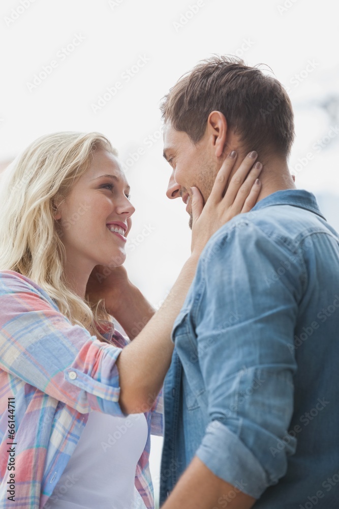 Cute young couple standing and facing each other Cute young couple standing and facing each other