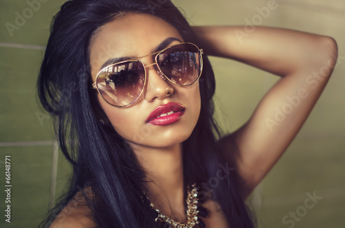 Beautiful young woman wearing sunglasses photo