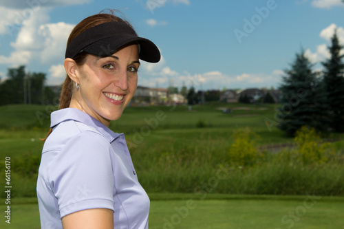 Attractive female golfer on the golf course