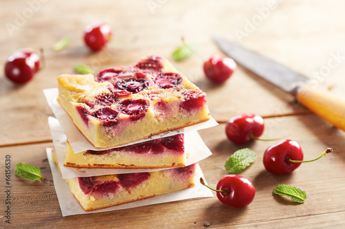 Cherry clafoutis pie on wooden table photo
