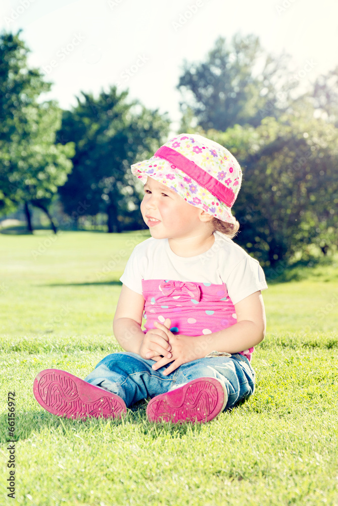 Child sitting on the grass Child sitting on the grass