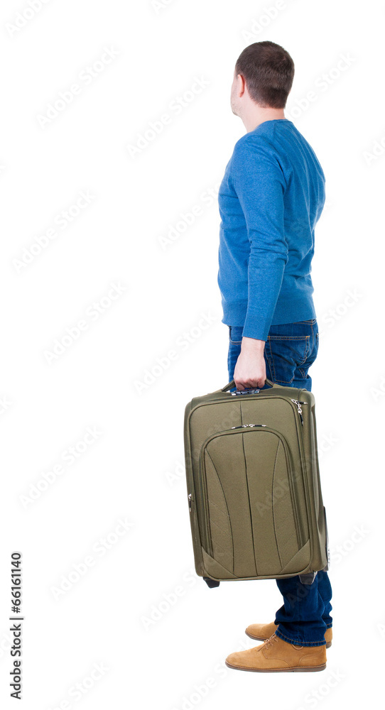 Back view of man with green suitcase looking up. Back view of man with green suitcase looking up.