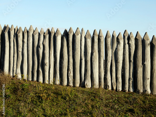 wooden palisade of the protective fence photo