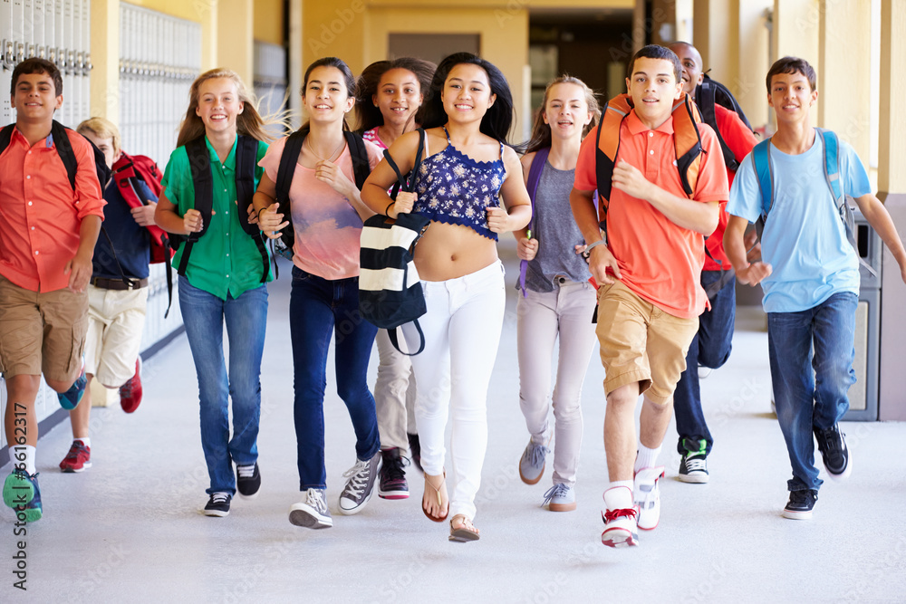 Fototapeta premium Group Of High School Students Running Along Corridor