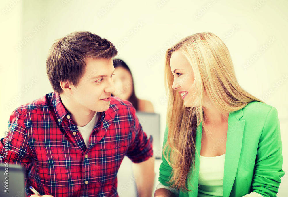 smiling students looking at each other at school smiling students looking at each other at school