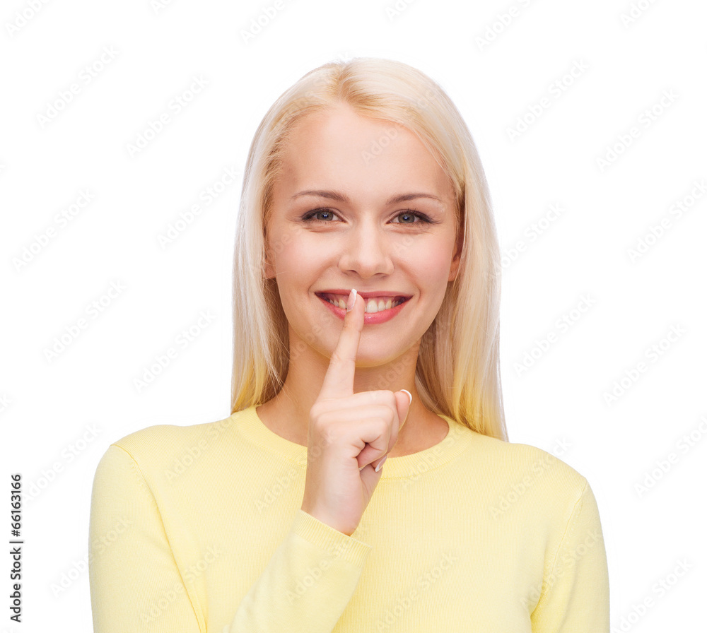 young woman with finger on her lip