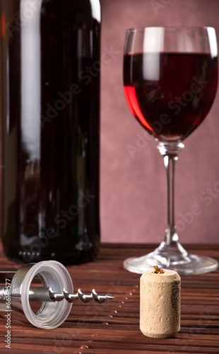 Cork and corkscrew with bottle and wine glass
