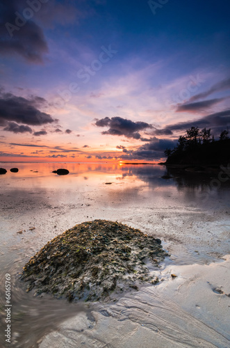 Tips of borneo sunset with stone vertical view