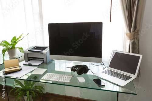 Modern home office with computer and labtop