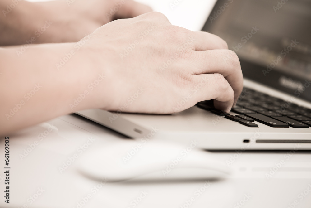 Hands of a man working on laptop Hands of a man working on laptop