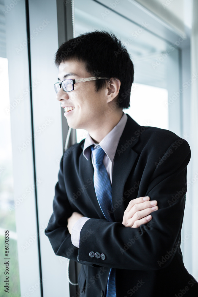 Portrait of a businessman looking at the window Portrait of a businessman looking at the window