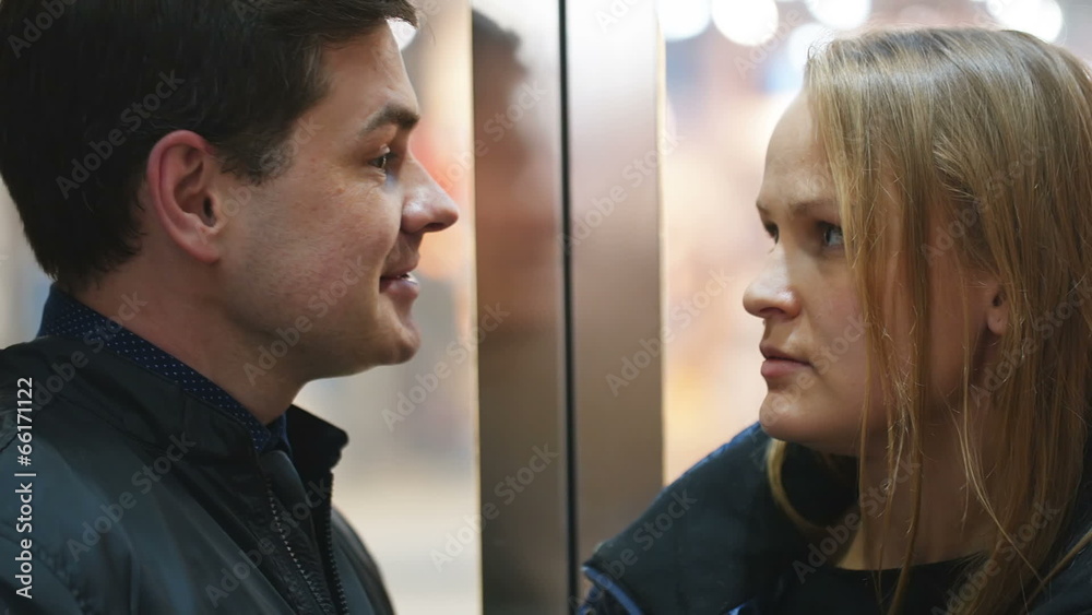 Man and woman talking vividly in lift Man and woman talking vividly in lift