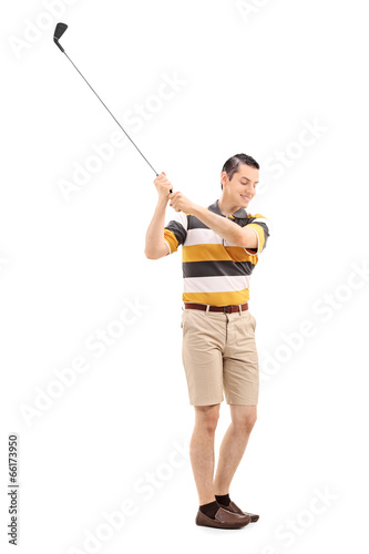 Full length portrait of a joyful man playing golf