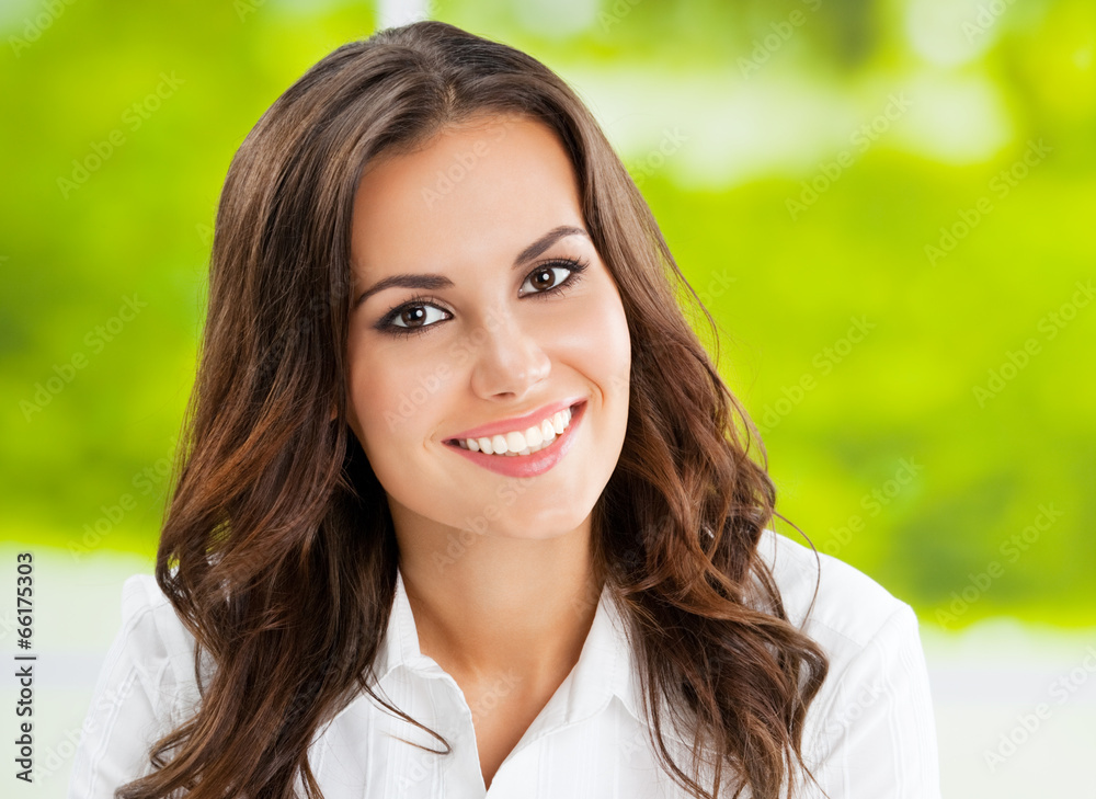 Young smiling cheerful businesswoman at office Young smiling cheerful businesswoman at office