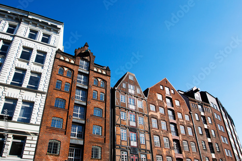 Facade of the old houses against blue sky