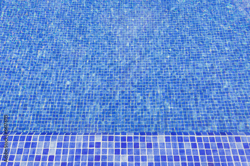 Textured surface of the pool water. With mosaic tiles.