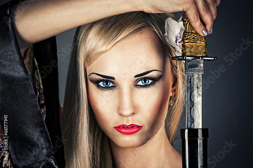 beautiful woman portrait with a samurai sword