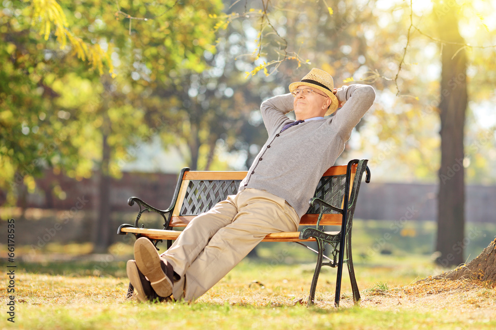 Senior man relaxing in park on a sunny day Senior man relaxing in park on a sunny day