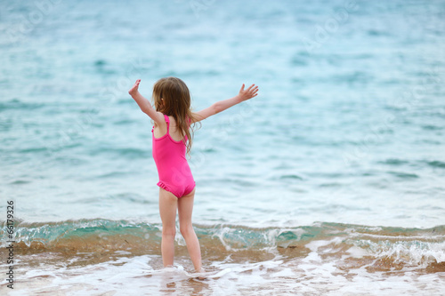 Cute little girl playing on a beach