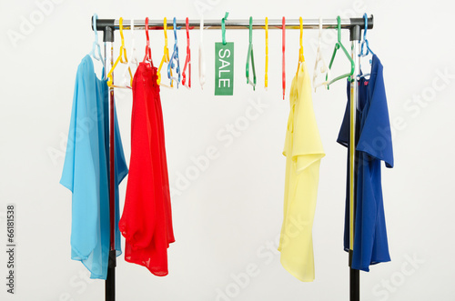 Almost empty rack of clothes and hangers after a big sale. © luanateutzi