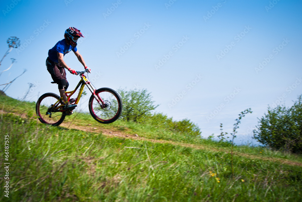 Dounhill cyclist in mountains